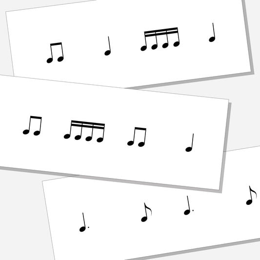Three cards with different rhythm exercises. Shown on a neutral colored background.