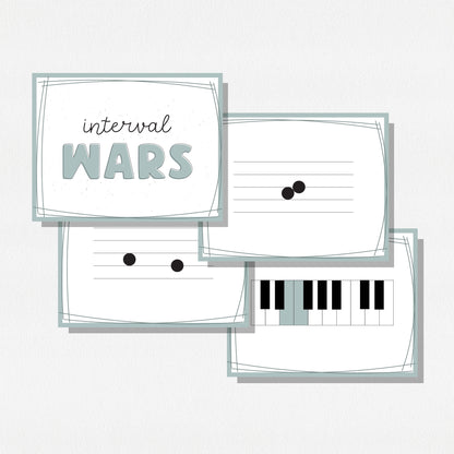 Four square cards of a music card game showing music notes on a staff, a piano keyboard, and a cover card with text that says "Interval Wars." Shown on a neutral colored background