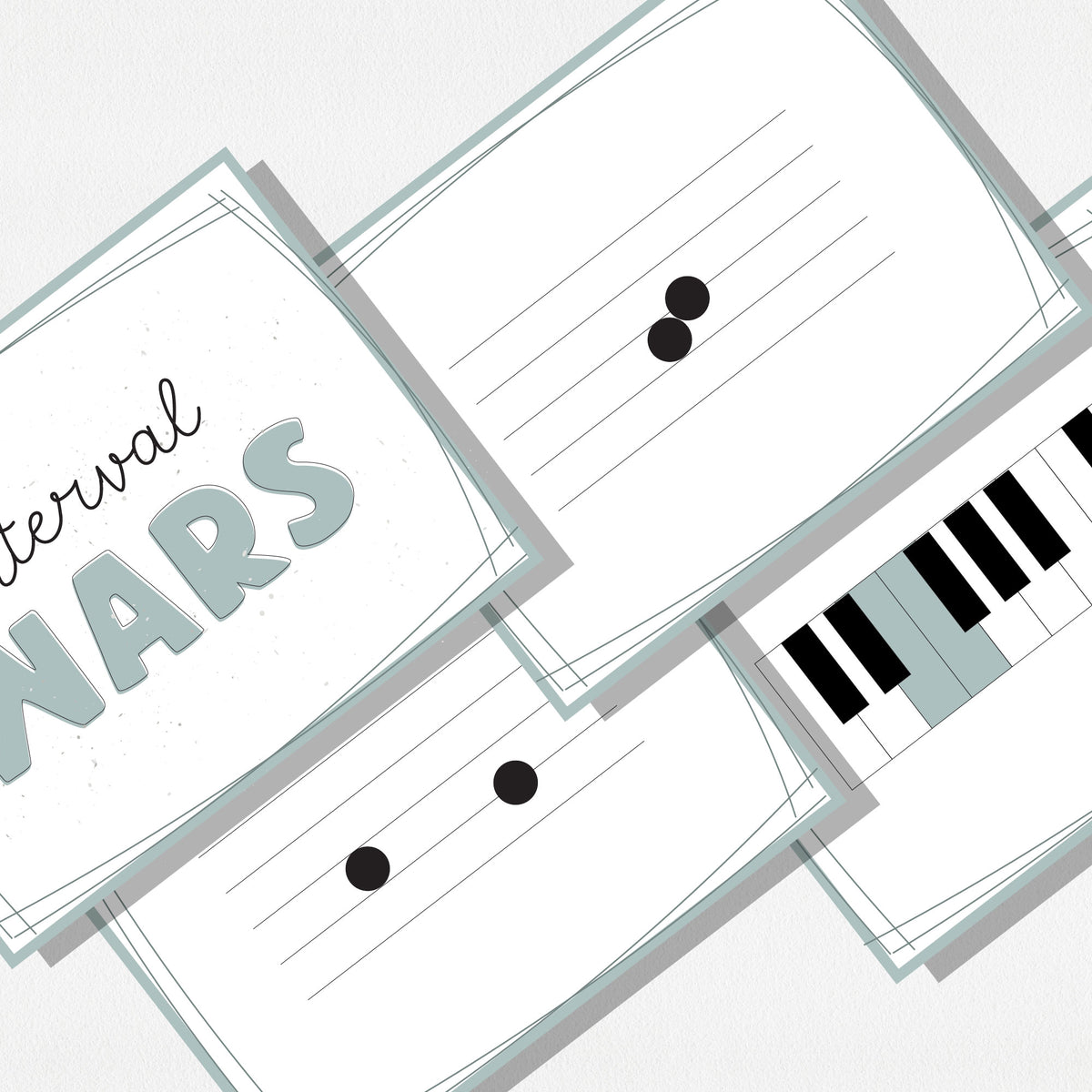 A zoomed in image of four square cards of a music card game showing music notes on a staff, a piano keyboard, and a cover card with text that says "Interval Wars." Shown on a neutral colored background