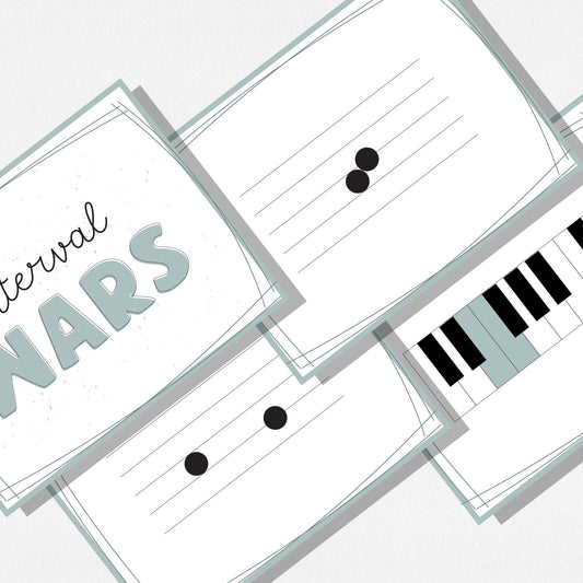 A zoomed in image of four square cards of a music card game showing music notes on a staff, a piano keyboard, and a cover card with text that says "Interval Wars." Shown on a neutral colored background