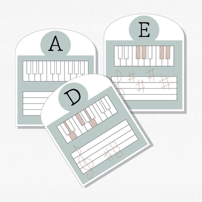 Three music theory cards with keyboards and staffs. Shown on a neutral colored background.